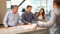 Gusramher Team Members looking at plans