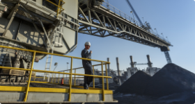 Man looking out at power generation station